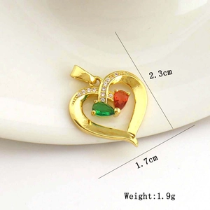 Macro view of heart pendant with red and green drop stones and size dimensions