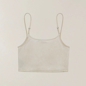 Close-up of beige cropped sports camisole with thin adjustable metal buckles