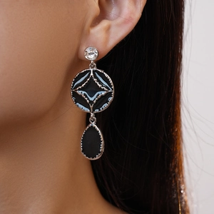 Detail of dark gothic style drop earrings with black enamel and sparkling rhinestones