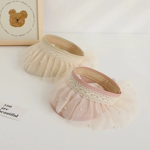 Detail of baby sun visor straw hats with lace lace trim and pearl mesh decorations