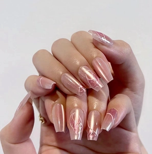 Detailed view of pink mermaid cat-eye press-on nails in coffin shape with leaf patterns