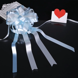 Detail of a large double-layered light blue and white spherical ribbon bow for weddings