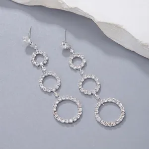 Sparkling silver fringe earrings with three rhinestone circles in an elegant drop style