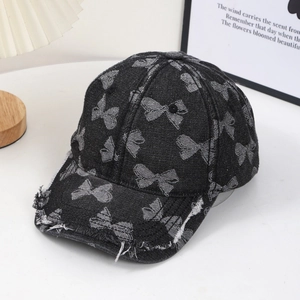 Vintage denim baseball cap with grey bow patterns and distressed frayed brim details