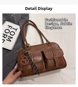 Detail of vintage brown tote bag with dual front pockets and metal buckle hardware