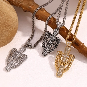 Detailed view of 18K gold plated cross pendants with crystals on woven chains for men