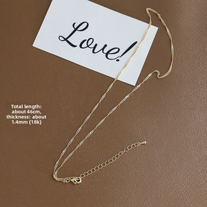 Detail of 14k gold-plated 1.4mm flat O-chain necklace with adjustable lobster clasp