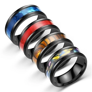 Macro view of five men's stainless steel rings featuring colorful resin and shell inlays
