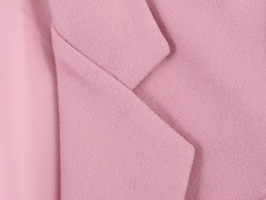 Macro close-up of pink wool-blend coat collar and smooth inner lining details