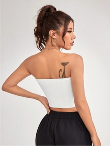 Close-up of white ribbed knit fabric texture on a tight-fitting athletic tube top