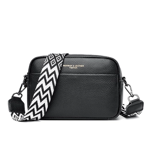 Black textured leather crossbody bag with 38mm wide ethnic style patterned shoulder strap