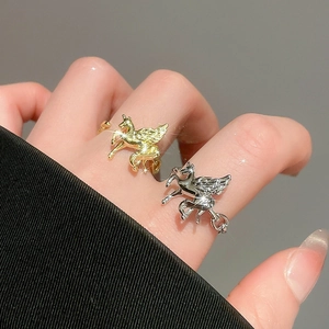 Detailed macro view of gold and silver adjustable Pegasus rings with cubic zirconia