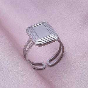 Detail view of silver stainless steel open ring with rectangular geometric top design