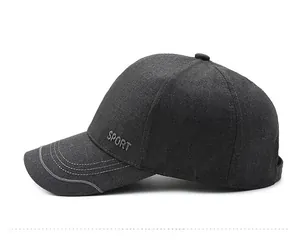 Detail of dark grey baseball cap showing textured fabric and SPORT letter embroidery
