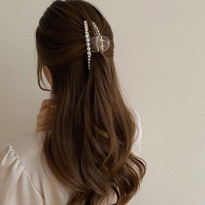 Elegant large pearl hair claw clip shown in use on long hair for a stylish look