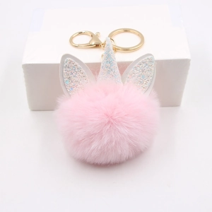 Pink plush unicorn keychain with gold metal ring and glitter ears on a white base