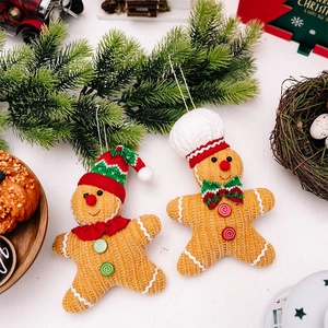 Detailed close-up of knitted gingerbread man ornaments with hats for Christmas tree decoration