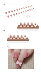 Short ballet press-on nails with nude blush gradient, 3D bows and crystal hearts