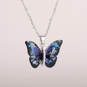 Detailed view of butterfly pendant with blue-purple starry texture and micro-inlaid zircon