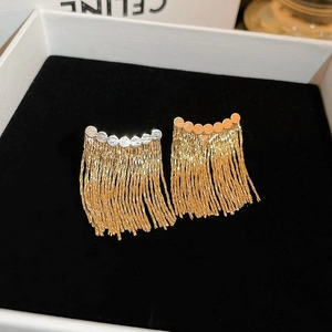 Elegant gold metal tassel earrings with long fringe chains in a black luxury jewelry box