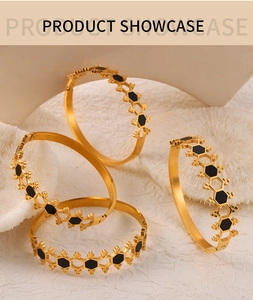 Detail of gold-plated honeycomb bracelet featuring hollow hexagonal frames and black acrylic