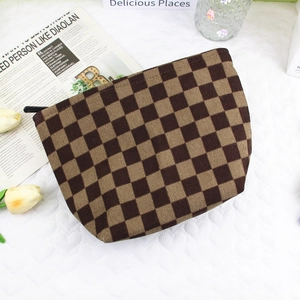 Corduroy checkerboard cosmetic bag in brown and beige with zipper on white background