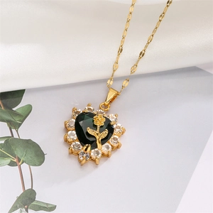 Detail of heart pendant with green gem, golden rose relief and pavé zircon border