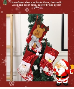 Close-up of Santa, elk, and snowman Christmas stockings hanging on a tree as festive decor