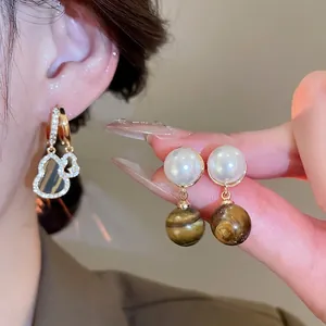 Vintage pearl tiger eye stone drop earrings with gold finish and rhinestone details