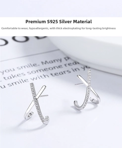 Detailed view of X-shaped 925 sterling silver earrings with zircon inlay and thick plating