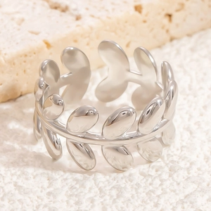 Detailed macro view of a silver stainless steel open ring featuring a leaf pattern design