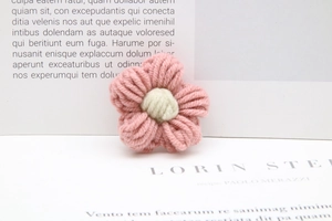 Macro shot of handmade pink and white crochet milk cotton flowers for DIY crafts