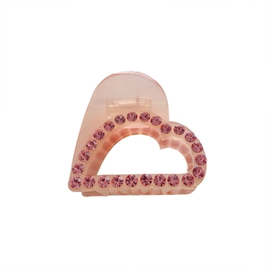 Pink heart-shaped acetate hair claw clip with rhinestones for elegant updo hairstyles