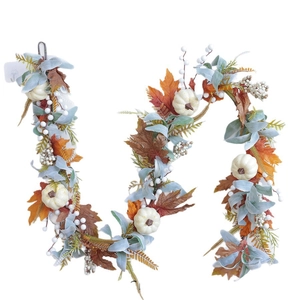 Autumn garland with pumpkins, maple leaves and berries for Thanksgiving home decor