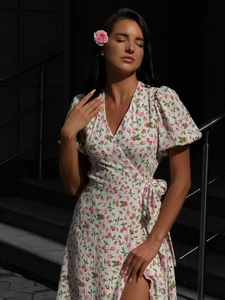 Detail of floral wrap dress with puff sleeves and tie-waist in lightweight cotton