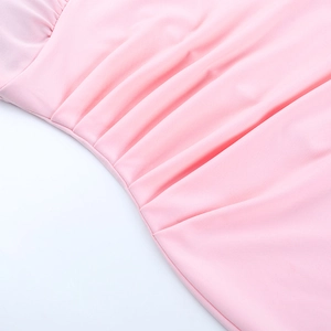 Close-up of pink ruched fabric detail and high-density stitching on fishtail gown
