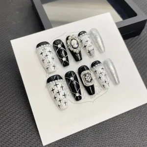 Detail of gothic press-on nails featuring vintage cameo and pearl embellishments