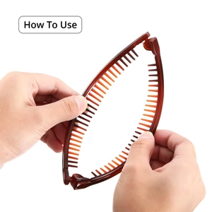 Close-up of flexible brown banana hair clip with hands demonstrating how to use the comb