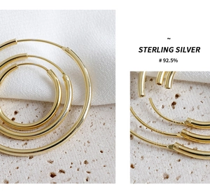 Detail view of S925 sterling silver golden hoop earrings in three sizes with hallmarks
