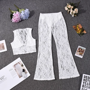 Flat lay of white lace two-piece set featuring V-neck crop top and flared high-waist pants