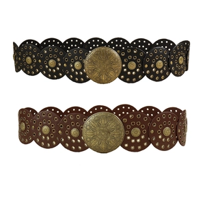 Detail of vintage bohemian leather waist belts with embossed bronze metal buckles