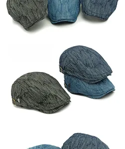 Detail of jacquard denim beret featuring vintage textures and bronze side buckles