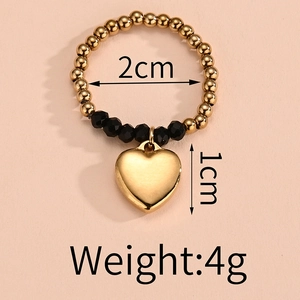 Detail view of elastic bead ring with heart pendant and dimensions 2cm inner diameter