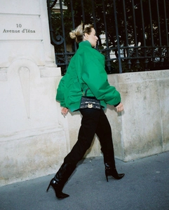 Detail of green oversized stand collar jacket and crocodile texture bag with metal logo