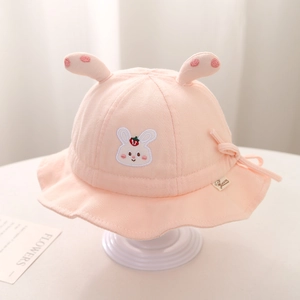Detailed view of pink baby bucket hat featuring 3D rabbit ears and strawberry embroidery