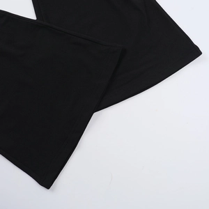 Detailed close-up of the double-stitched hem on black casual knit trousers
