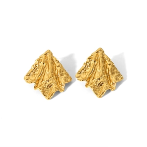 Macro shot of 18K gold plated earrings featuring irregular textured wrinkle finish