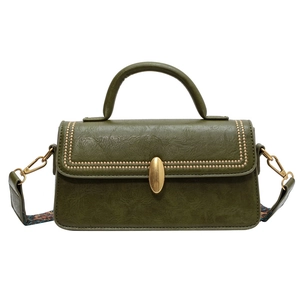 Vintage dark green crossbody bag with golden buckle and patterned shoulder strap