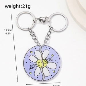 Detail of purple acrylic heart magnet keychains with flower and LOVE YOU text engravings