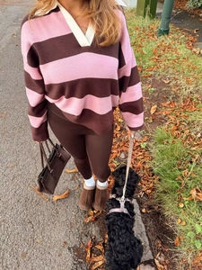 Outdoor lifestyle shot of a striped polo knit sweater and brown leggings for fall